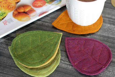 Bring that colorful fall feeling inside your home by creating a few vibrant felt coasters to protect your coffee table from those steaming cups of hot cocoa you'll be sipping.