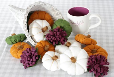 You can modernize your "horn of plenty" centerpiece this season by painting the basket white and creating some delightful felt gourds and flowers to fill it.