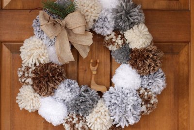 'Tis the season to make a cozy yuletide statement with this fuzzy pom pom wreath that you made yourself.