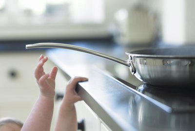 Baby reaching for hot frying pan on stove