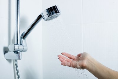Hand under shower spray