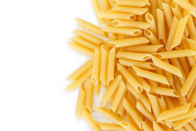 dry pasta penne Italian food white background.