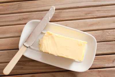 Directly Above Shot Of Butter And Knife On Wooden Table