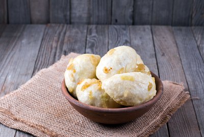 Traditional dumplings with onion on a wooden table
