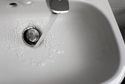 High Angle View Of Water Running From Faucet In Sink