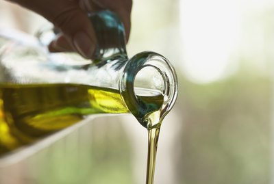 Olive oil pouring from bottle