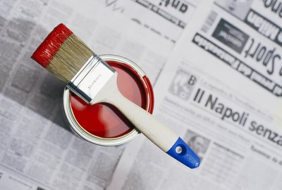 Red paint on a newspaper.