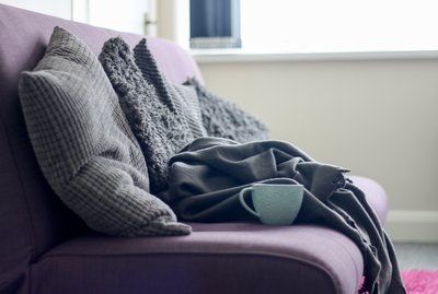 sofa with cushions and blankets