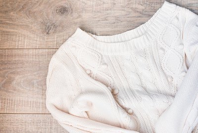 Women's autumn, winter clothes - white knitted pullover oversize, top view. Flat lay.