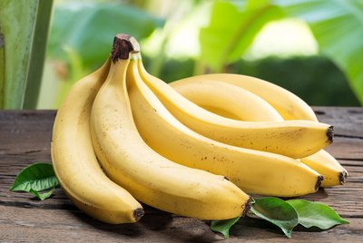 Banana bunch on the wooden table.