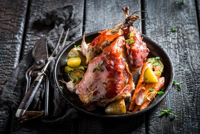 Fresh pheasant with bacon and spices on dark background