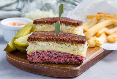 Classic reuben sandwich, served with dill pickle, potato chips, horizontal