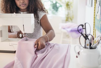 Black woman using sewing machine