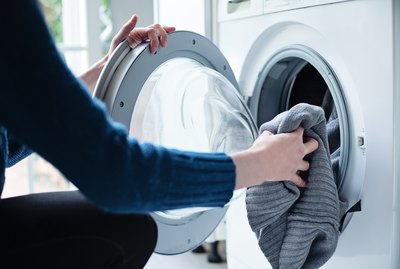 Woman loading washing machine