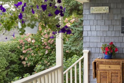 Front Porch of home close up with Hanging Baskets in summer