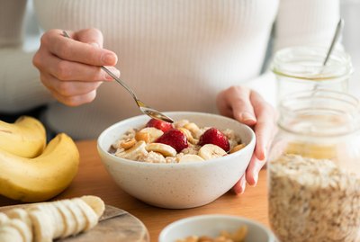 Woman eating oatmeal porridge