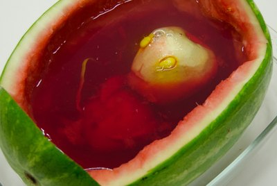 Carved apple "alien" in watermelon filled with red Jello