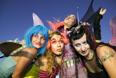 Women wearing fairy costumes posing together