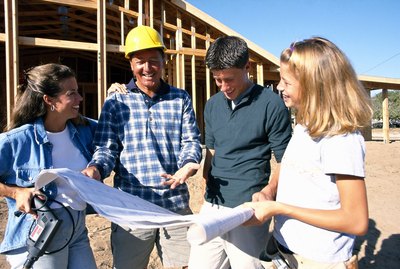 Family looking at blueprints