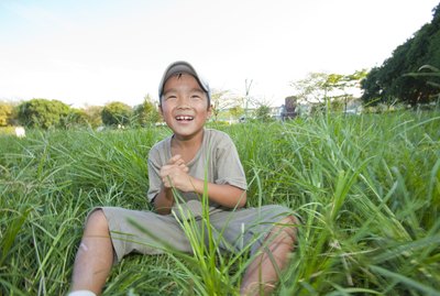 Boy sitting on grass, Japan