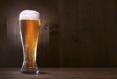 Glass beer on wood background