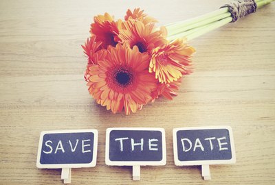 Save the date written on blackboard with flower