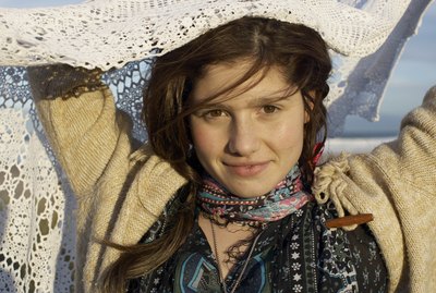 Portrait of teenage girl (16-17) holding shawl, smiling