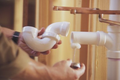 Plumber connecting PVC pipes