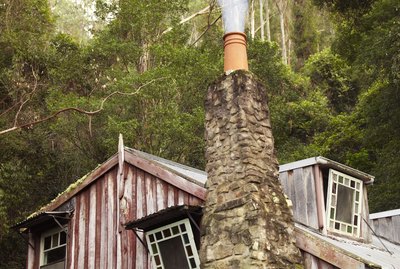Country home with smoking chimney pot
