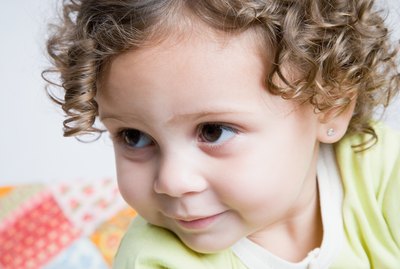Portrait of baby girl with curly hair