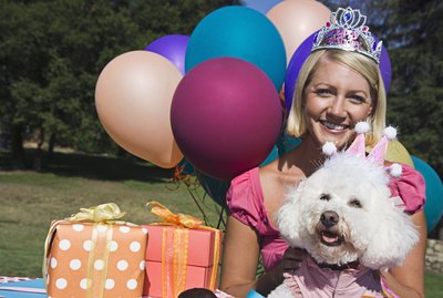 Woman and poodle with gifts and balloons