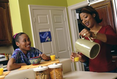 Mother and daughter eating breakfast