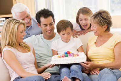 Family in living room with birthday cake