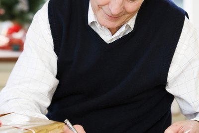 Man writing greeting cards