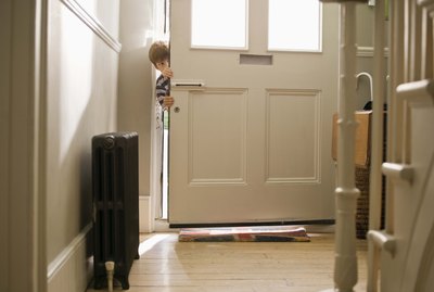 Boy sneaking in door