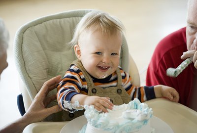 Messy one year old with birthday cake