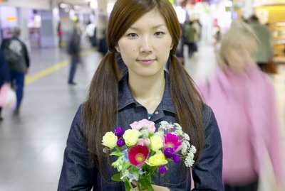 Woman holding flowers in airport