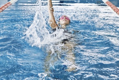 Woman swimming in indoor pool