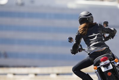 Back view of woman motorcyclist