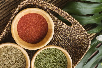 Spices in basket on table outdoors, overhead view