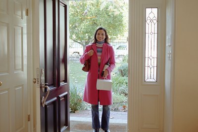 Woman standing at front door, holding pastry box