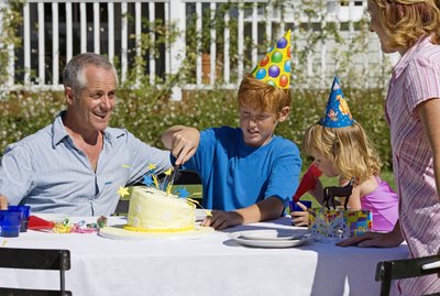 Teenage boy cutting cake