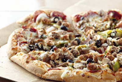 pizza sitting on cardboard box