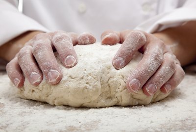 hands kneading bread dough
