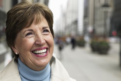 Senior woman standing on sidewalk