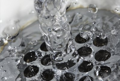 Close-up of water flowing through drain in sink