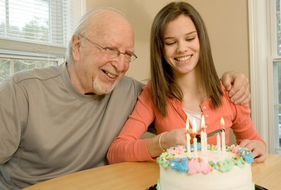 Grandfather and granddaughter with birthday cake