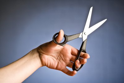 Person holding scissors