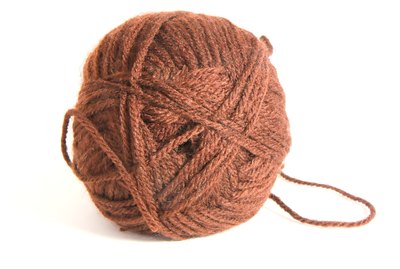 Ball of brown wool thread for knitting isolated