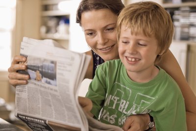 Mother and son reading newspaper together